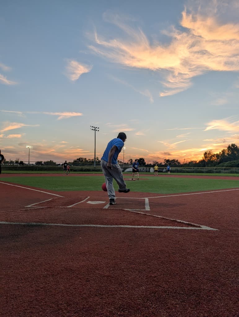 Player kicking a ball at a Gem City Social Sports Thursday kickball game