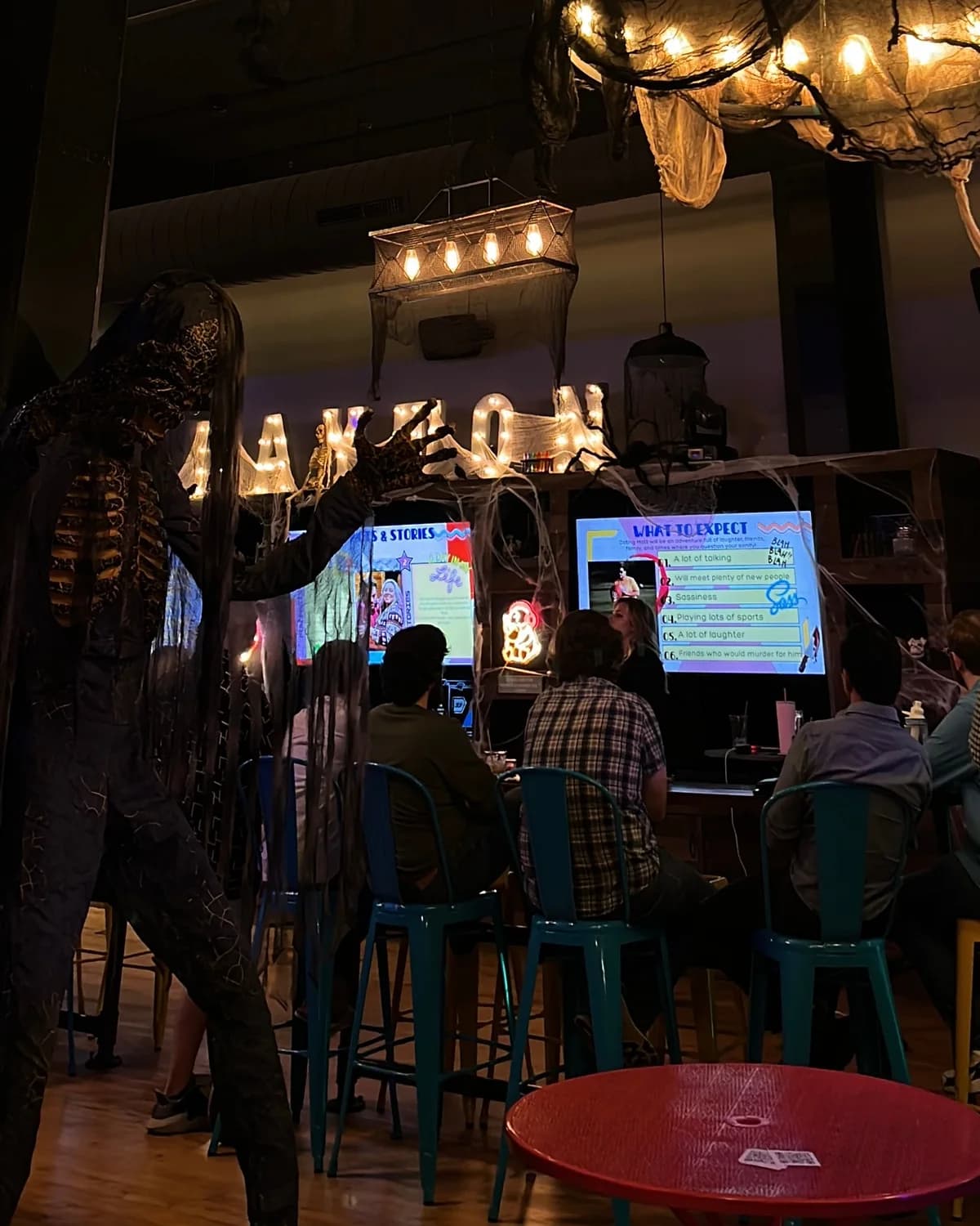 A skeleton and cobwebs decorating the bar at Two Social